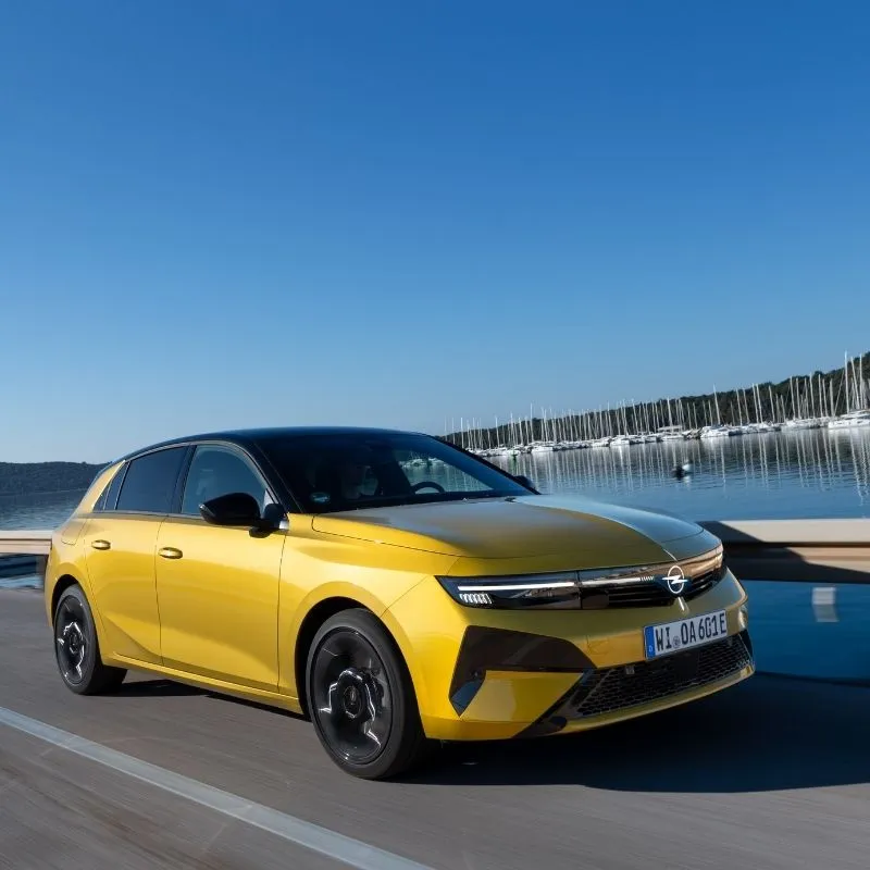 Opel Astra Electric 2026: 454 km de autonomia 3 O Opel Astra Electric 2026 amarelo a evoluir junto a um lago